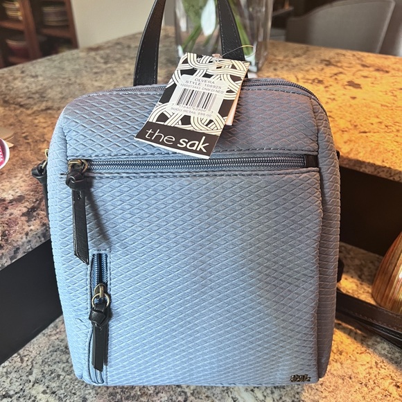 The Sak Handbags - NWT the Sam denim blue small texture watherproof backpack